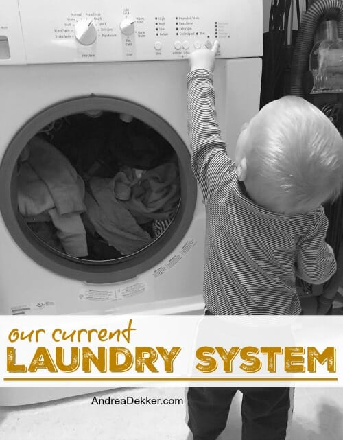 little boy helping with laundry