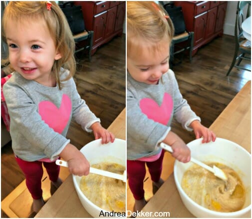 little girl helping to mix batter