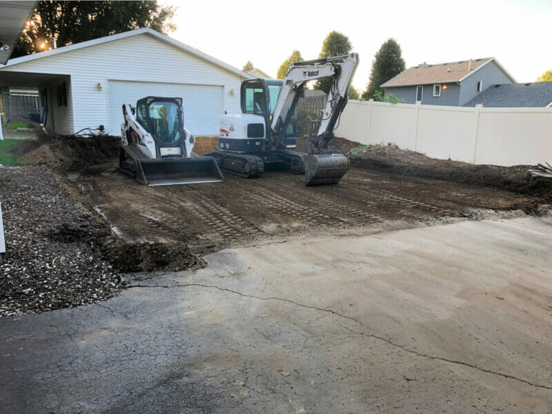 digging up the driveway for a pool