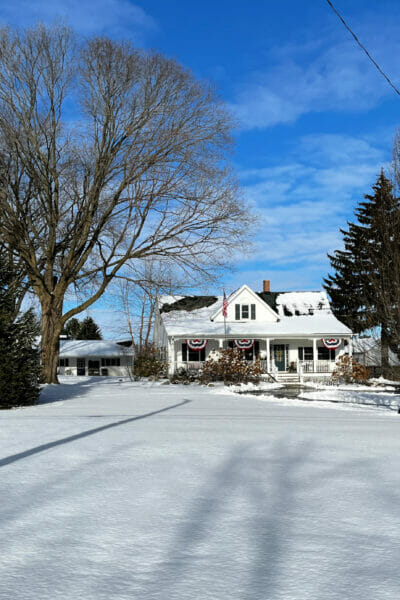 sunny snowy farmhouse