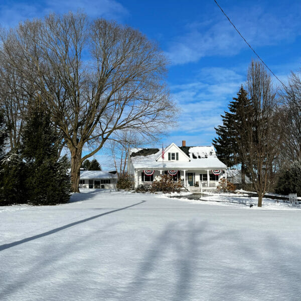 sunny snowy farmhouse